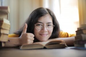 woman giving thumbs up for improving your writing